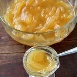 Large glass bowl of babaco preserves next to a small bowl of them.