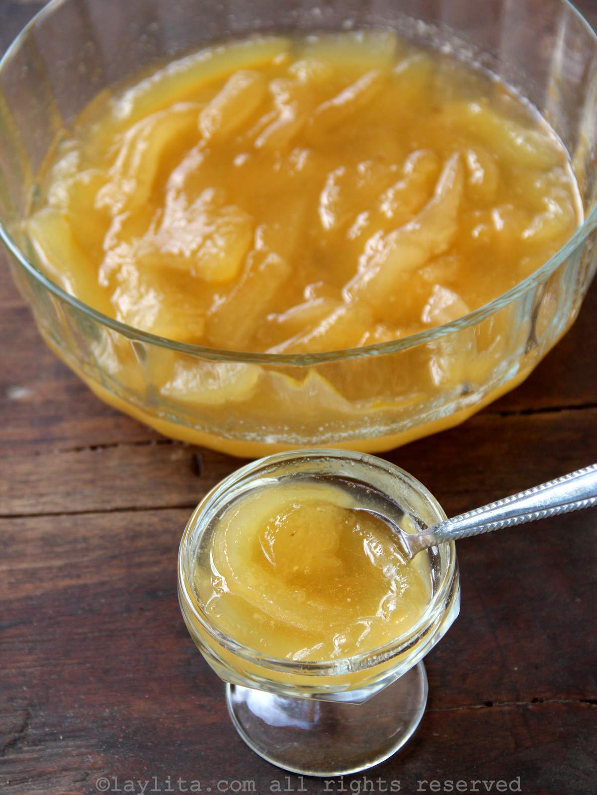 Large glass bowl of babaco preserves next to a small bowl of them.