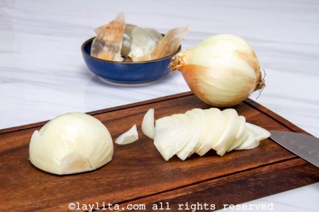 Sliced white onions on a cutting board