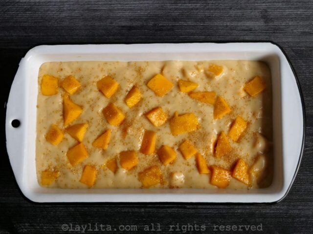 Add the rest of the diced mango on top of the batter. Sprinkle the brown sugar on top.