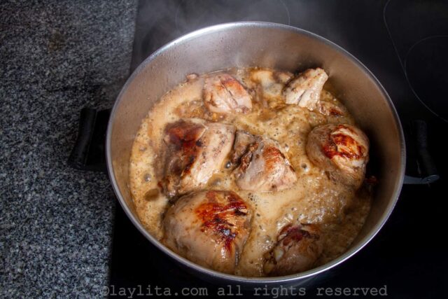 Chicken in Coca Cola sauce cooking in a pan