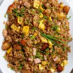 Overhead shot of Peruvian style chicken fried rice served on a white platter