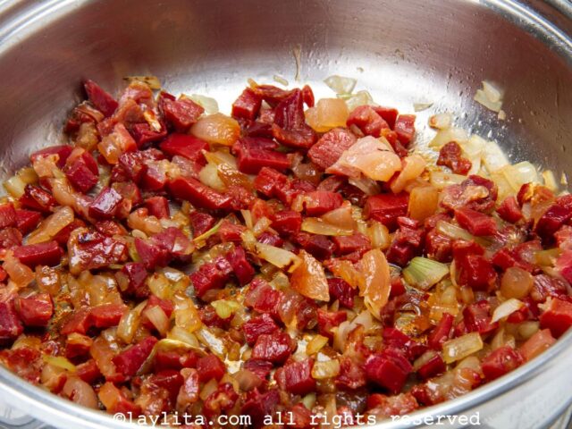 Ham and onions cooking in a frying pan