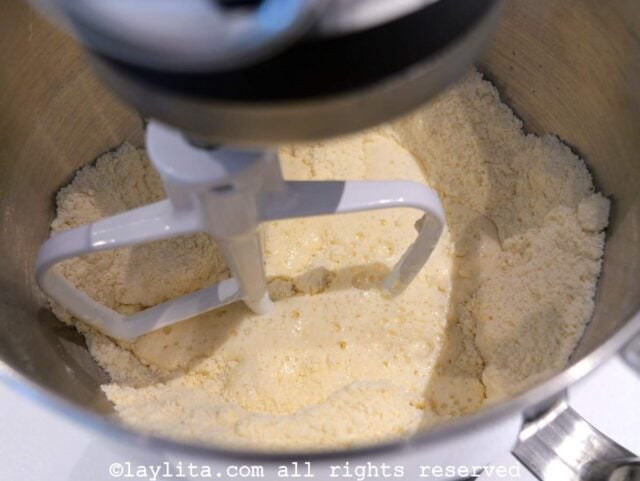 Liquid being added to the flour mix in a mixer bowl