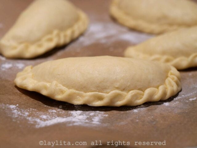 Uncooked empanadas on a board