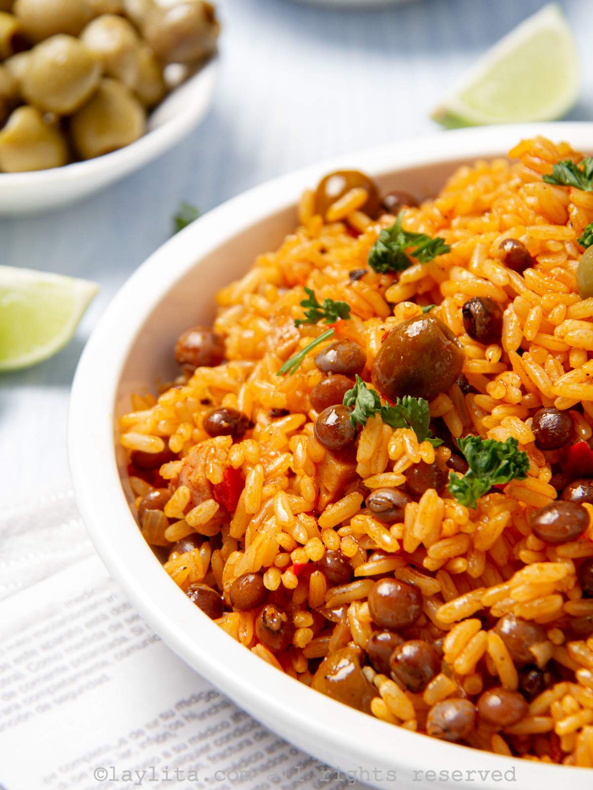 Close up of rice with pigeon peas in a white bowl, showing half of the bowl.