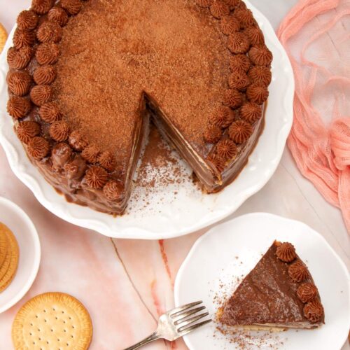 Overhead shot of Venezuelan marquesa de chocolate on a cake stand with one slice missing
