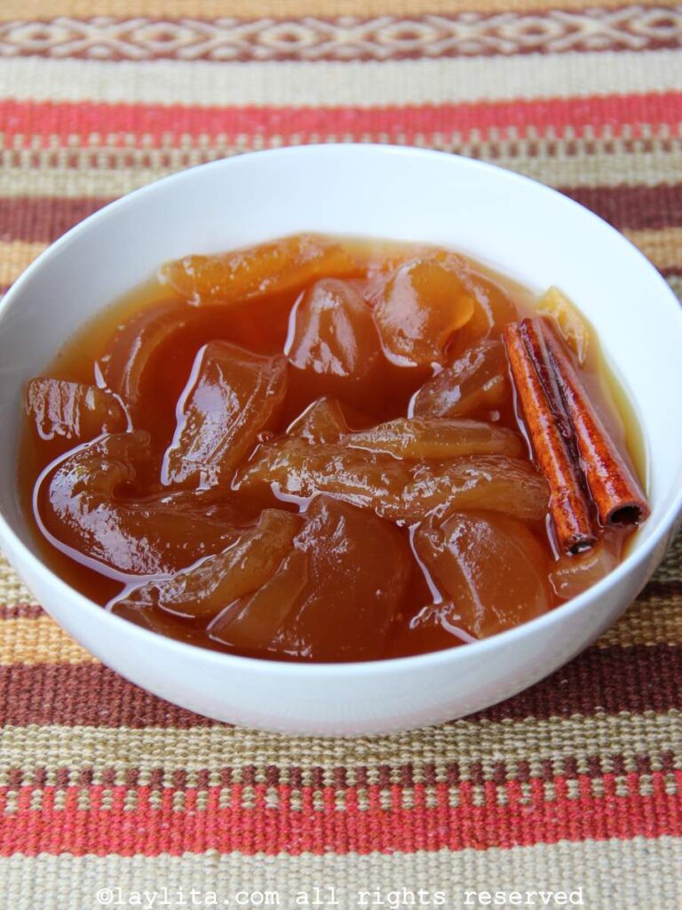 Ecuadorian babaco preserves made with brown sugar in a white bowl with a cinnamon stick