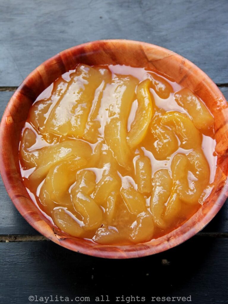 Overhead shot of dulce de babaco preserves in a wooden bowl.