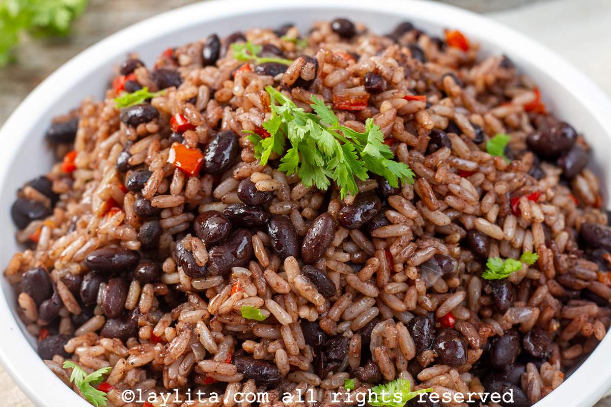 Close up of gallo pinto served in a shallow white serving bowl topped with cilantro