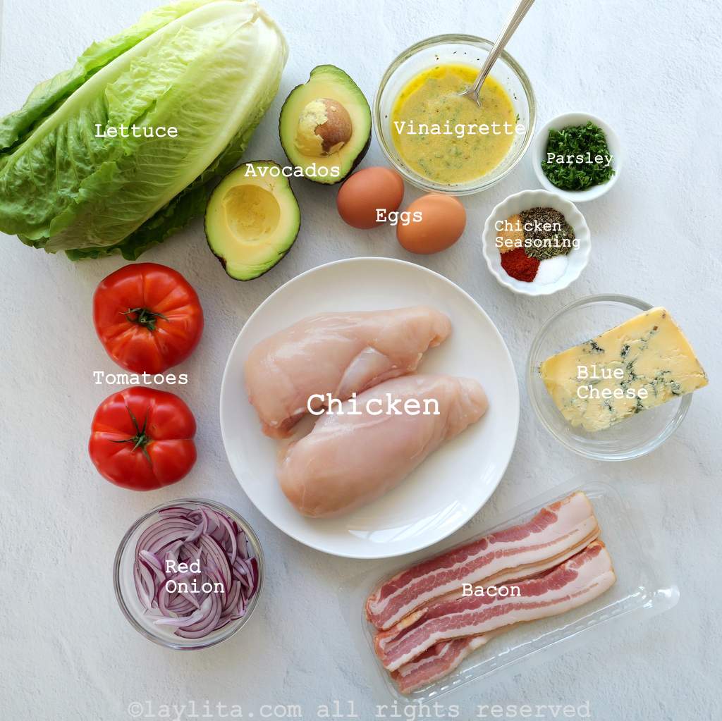 Ingredients with text labels for Chicken Cobb salad on a counter