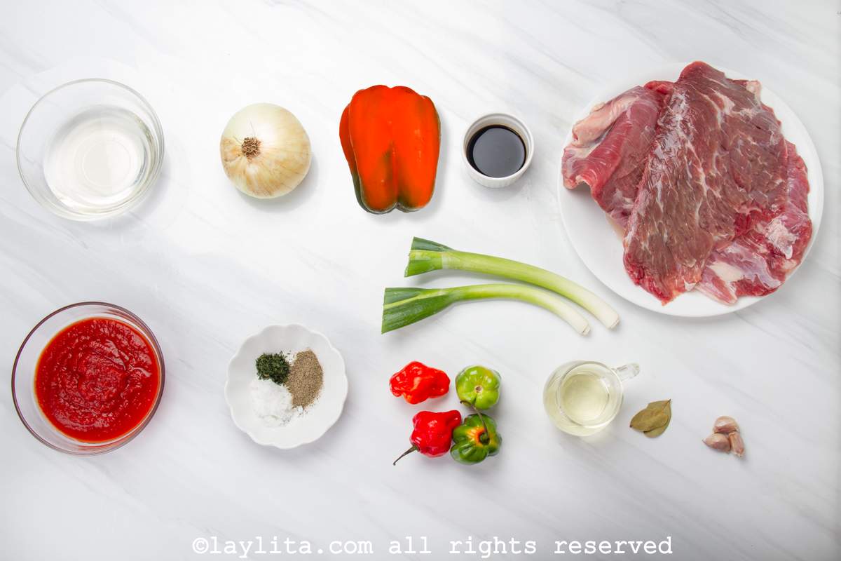 Ingredients for Cuban Ropa Vieja shredded beef on a white counter
