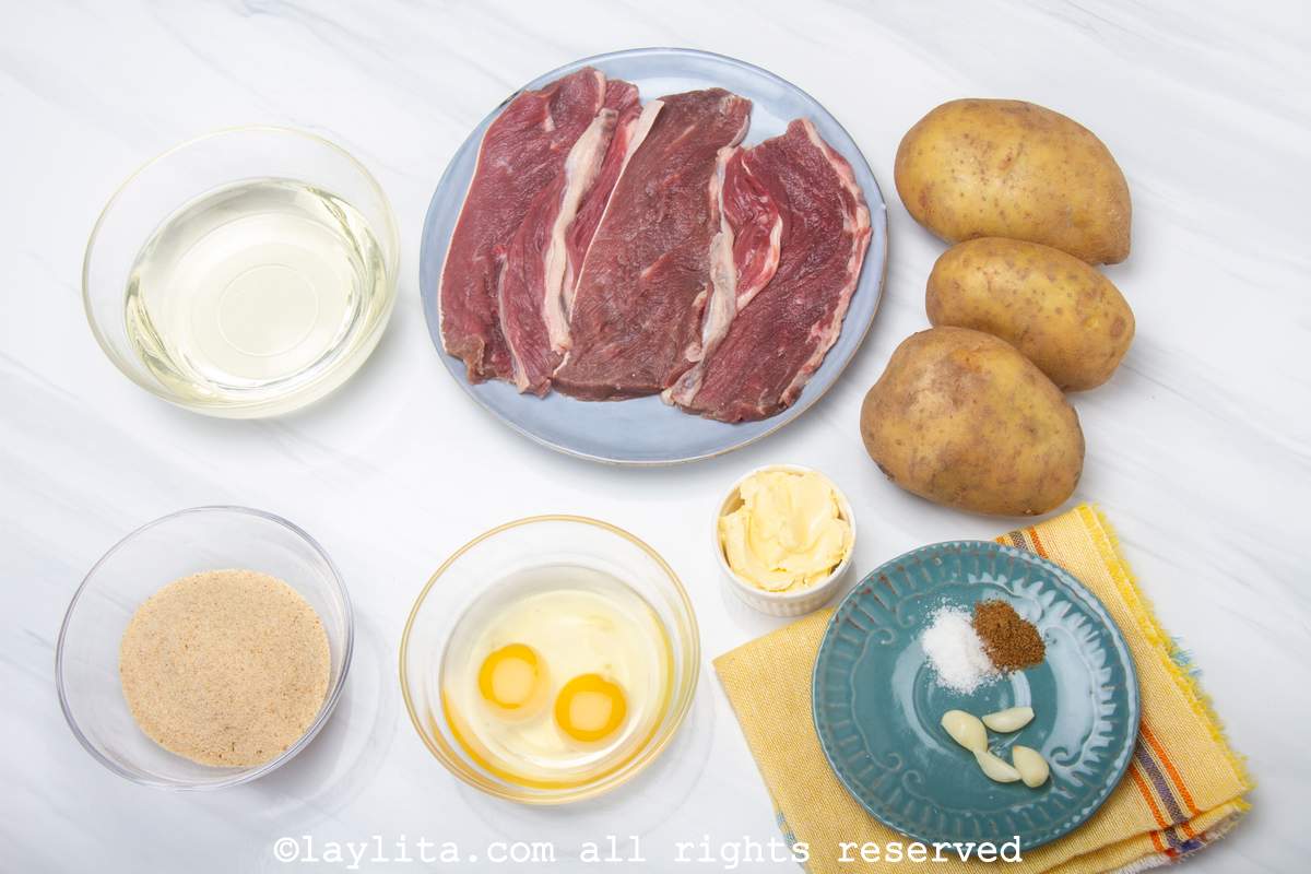 Ingredients needed to make thin breaded milanesa steaks on a counter. 