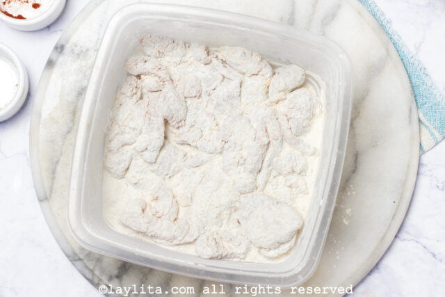 Coating chicken strips with flour