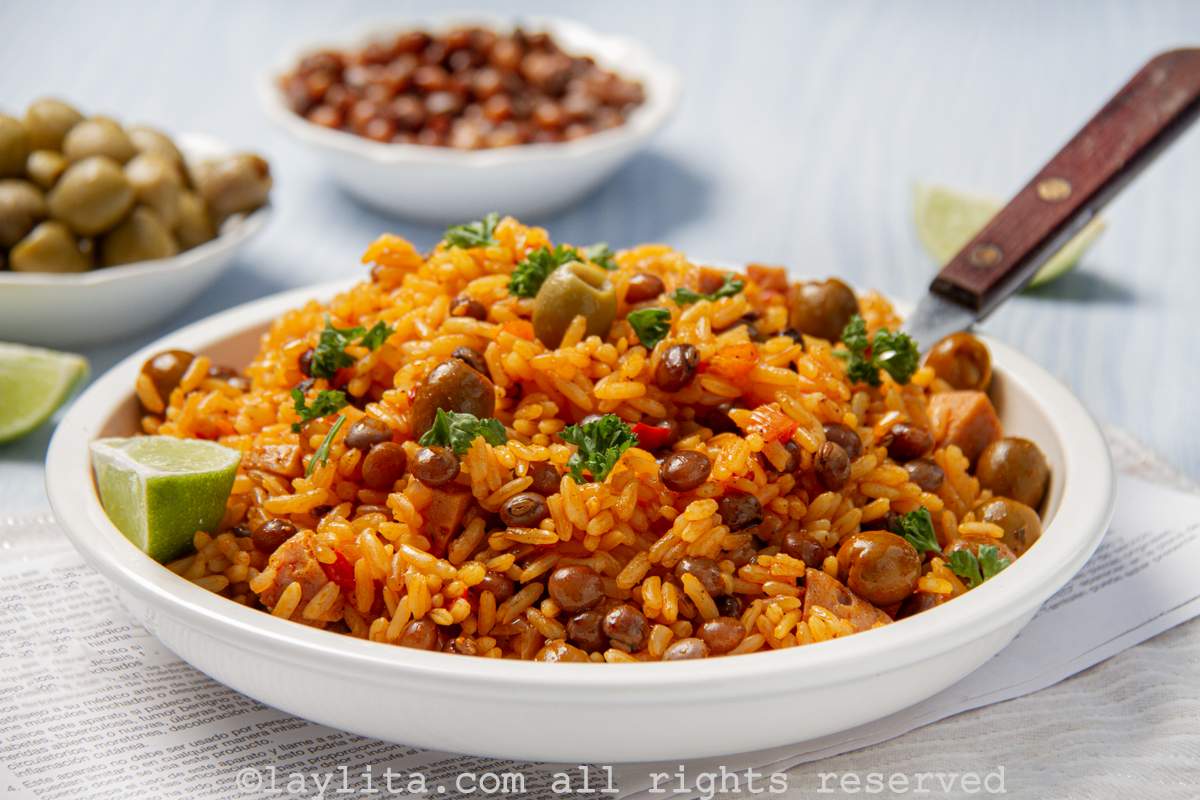 White serving bowl filled with Puerto Rican style arroz con gandules or rice with pigeon peas