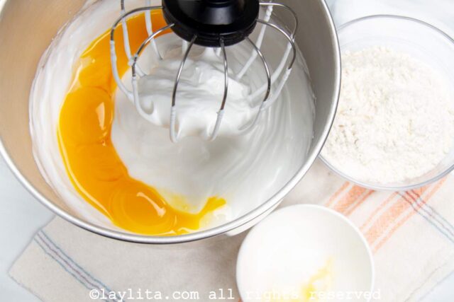 Adding the egg yolks to a mixer bowl