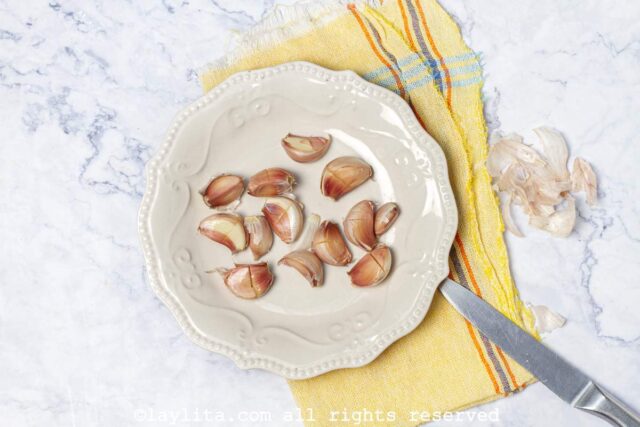 Unpeeled whole garlic cloves in a plate