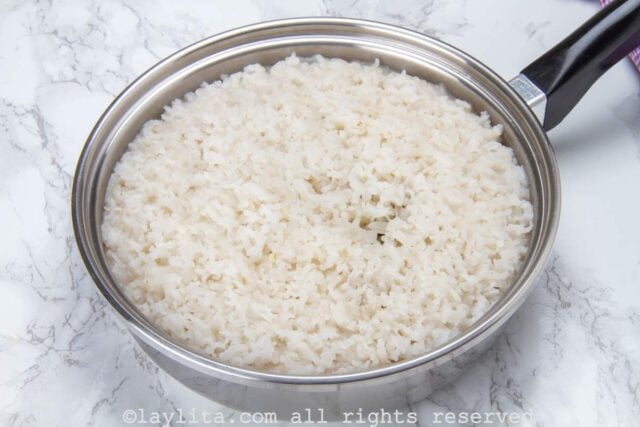 A pot of cooked rice on a marble counter