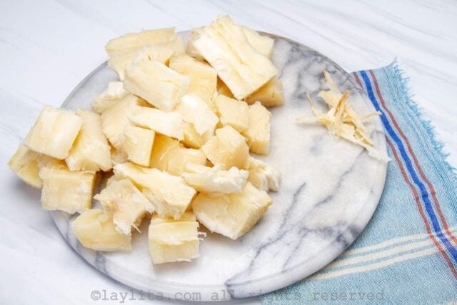 Cooked yuca pieces on a board