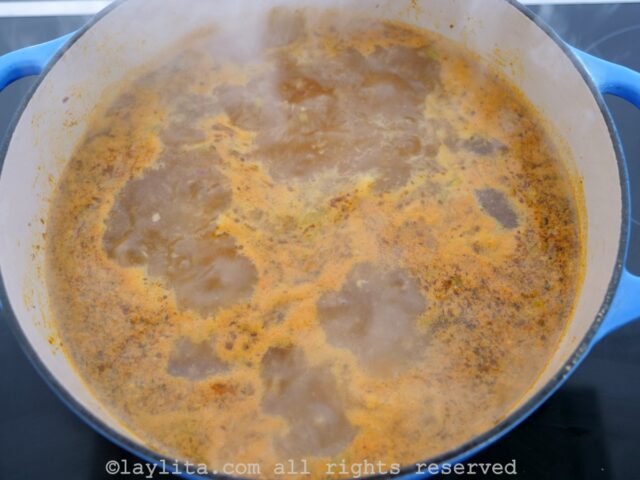 Soup broth boiling in a pot