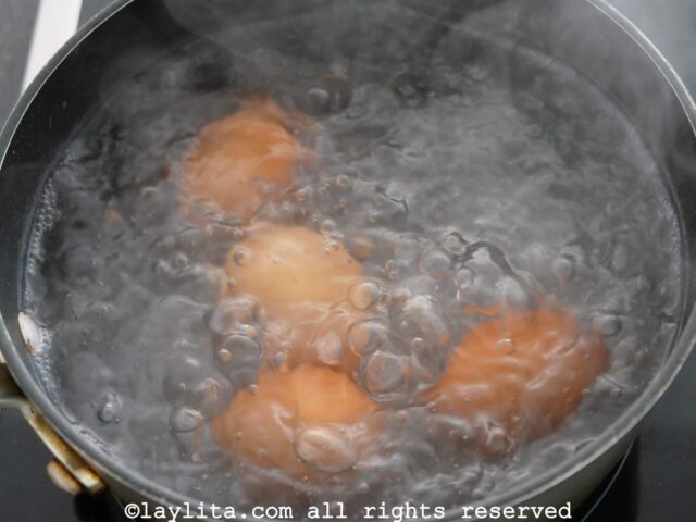 Four eggs being boiled in water