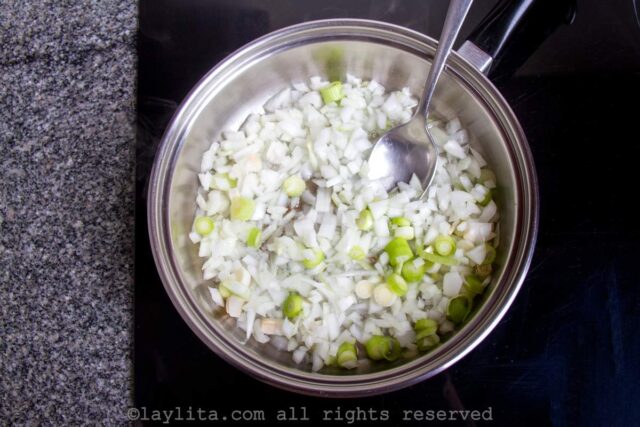 Cooking onions for sofrito in a pan