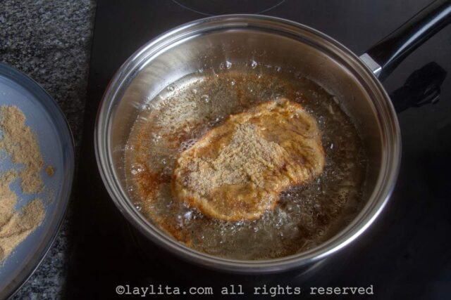 Pan frying the thin breaded milanesa steaks