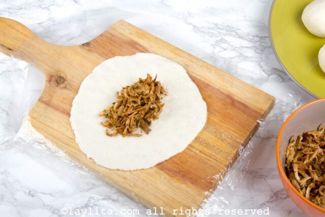 Chicken filling on a cornmeal empanada disk