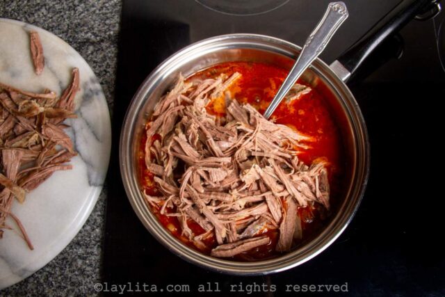 Mixing the shredded beef with the sofrito for Ropa Vieja