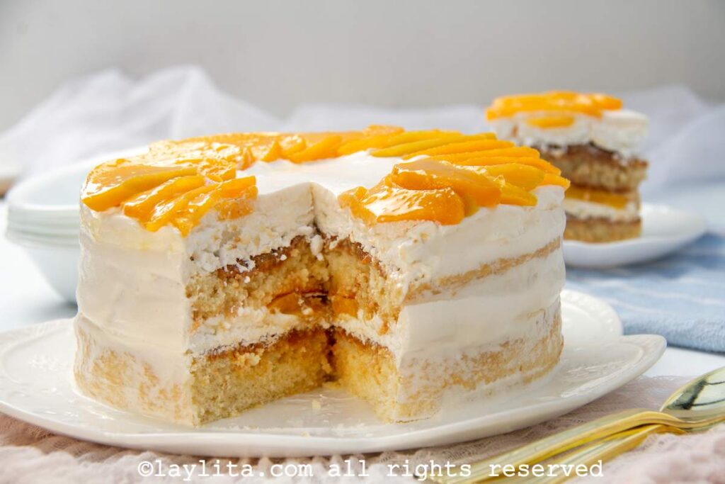 Torta chaja cake on a white plate with a slice missing to show the layers.