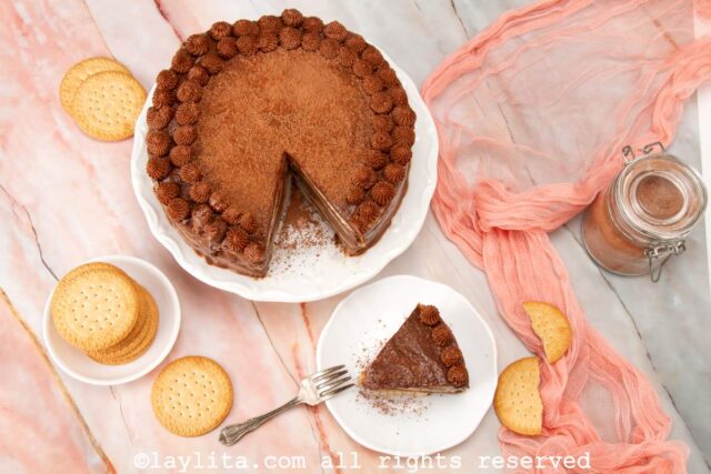 Overhead shot of Venezuelan chocolate marquesa dessert on a cake stand with one slice on the side