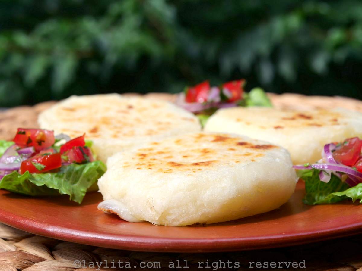 A terracotta plate with three patties made from mashed cassava or yuca root