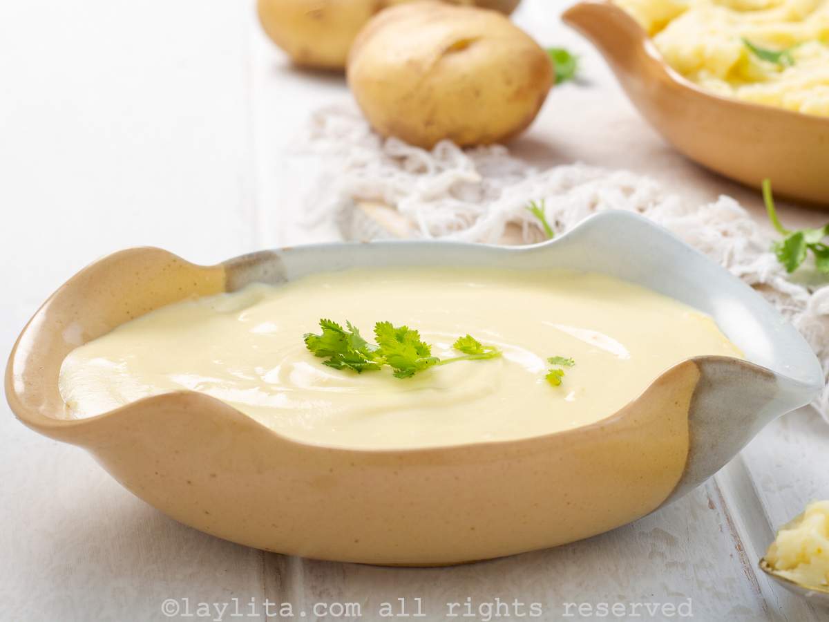 Close-up of a bowl of creamy poato purée with potaoes and another bowl in the background