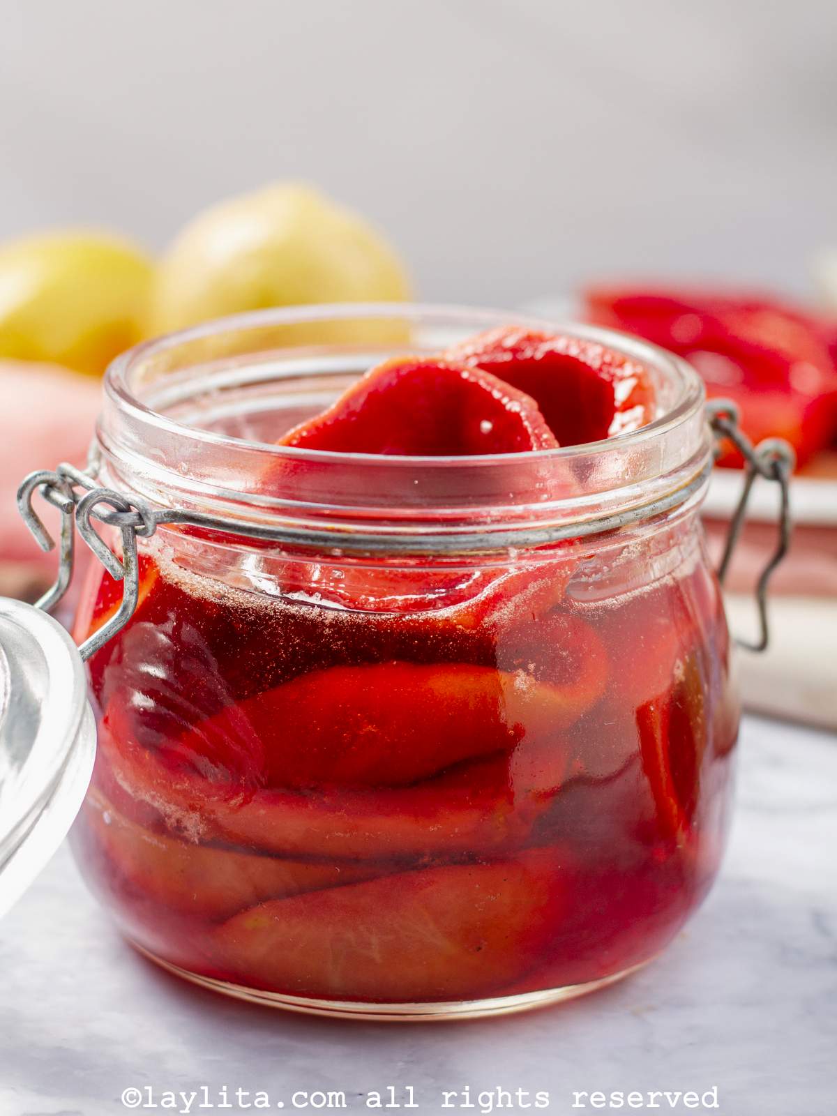 Closeup of casquitos de guayaba or candied guava shells in a jar with syrup