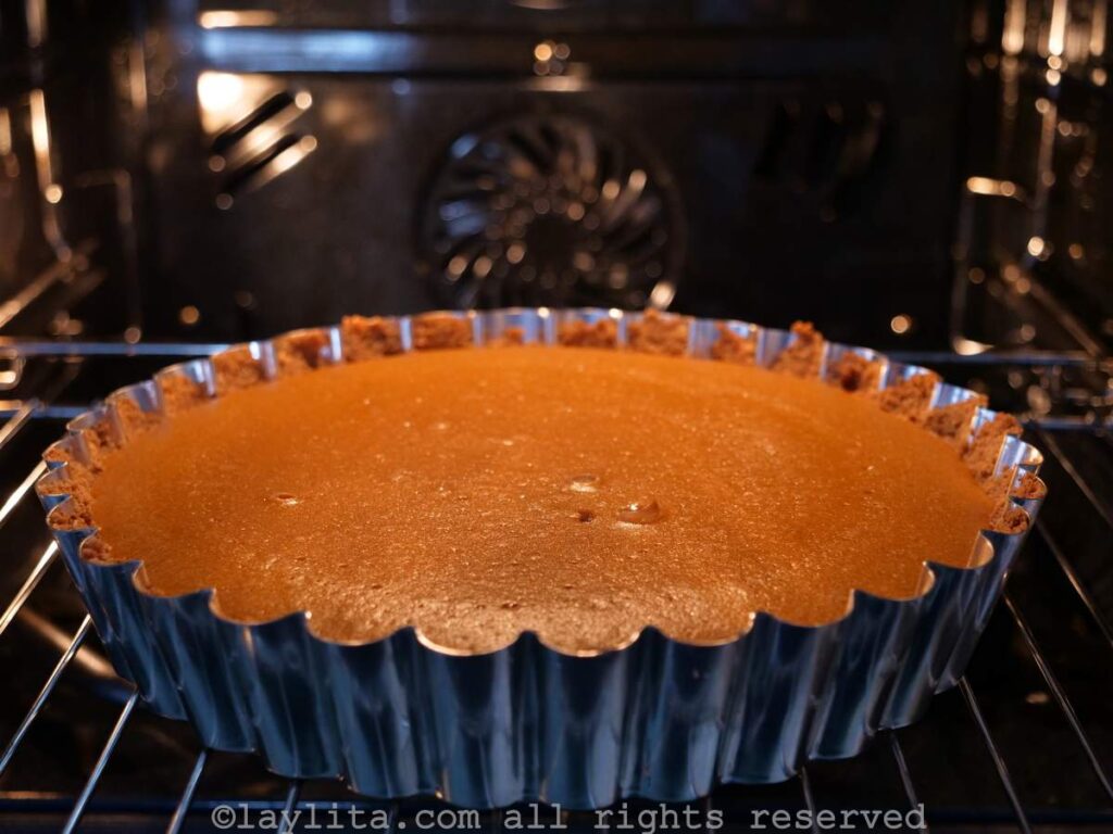 Pumpkin pie baking in the oven.