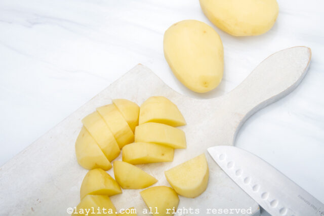 Potato chunks on a cutting board