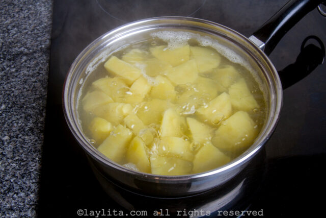 Potato chunks cooking in water on the stove