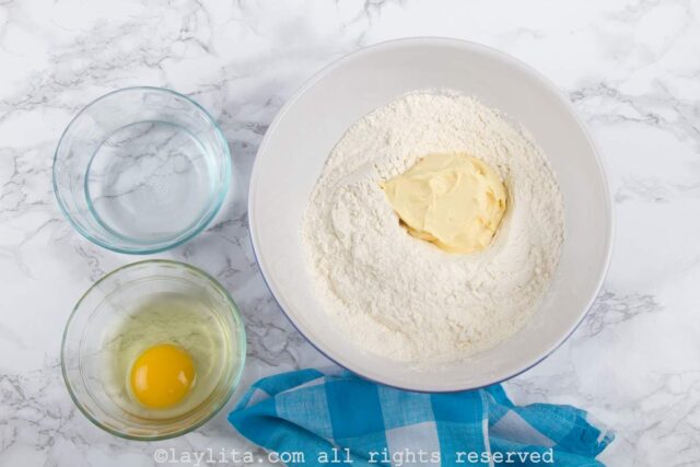 Flour and butter being mixed in a bowl