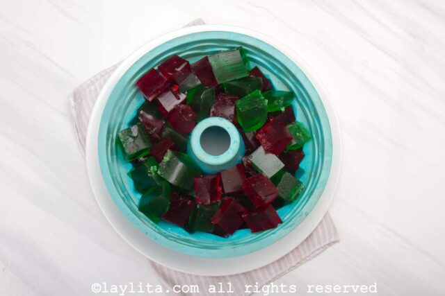 Green and red jello cubes in a mold
