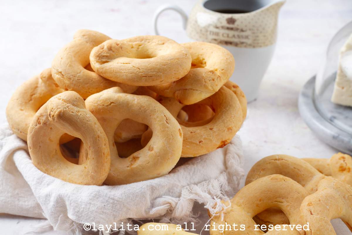 A basket full of Chipa cheese breads with a cup of coffee in the backgroun