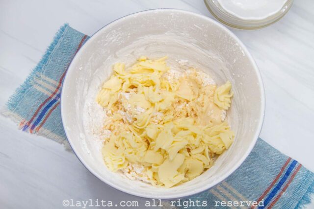 Tapioca starch and grated cheese being added to the mixing bowl