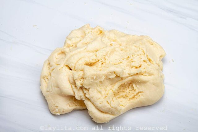 A soft pliable dough made with cheese and tapioca starch on a white counter