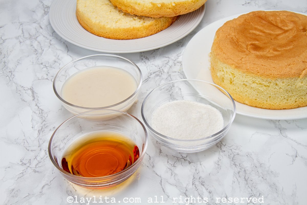 Ingredients for the soursop syrup or almíbar de guanábana on a counter with a sponge cake in the background