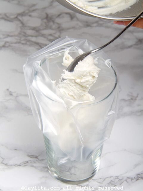 Italian meringue being placed into a piping bag