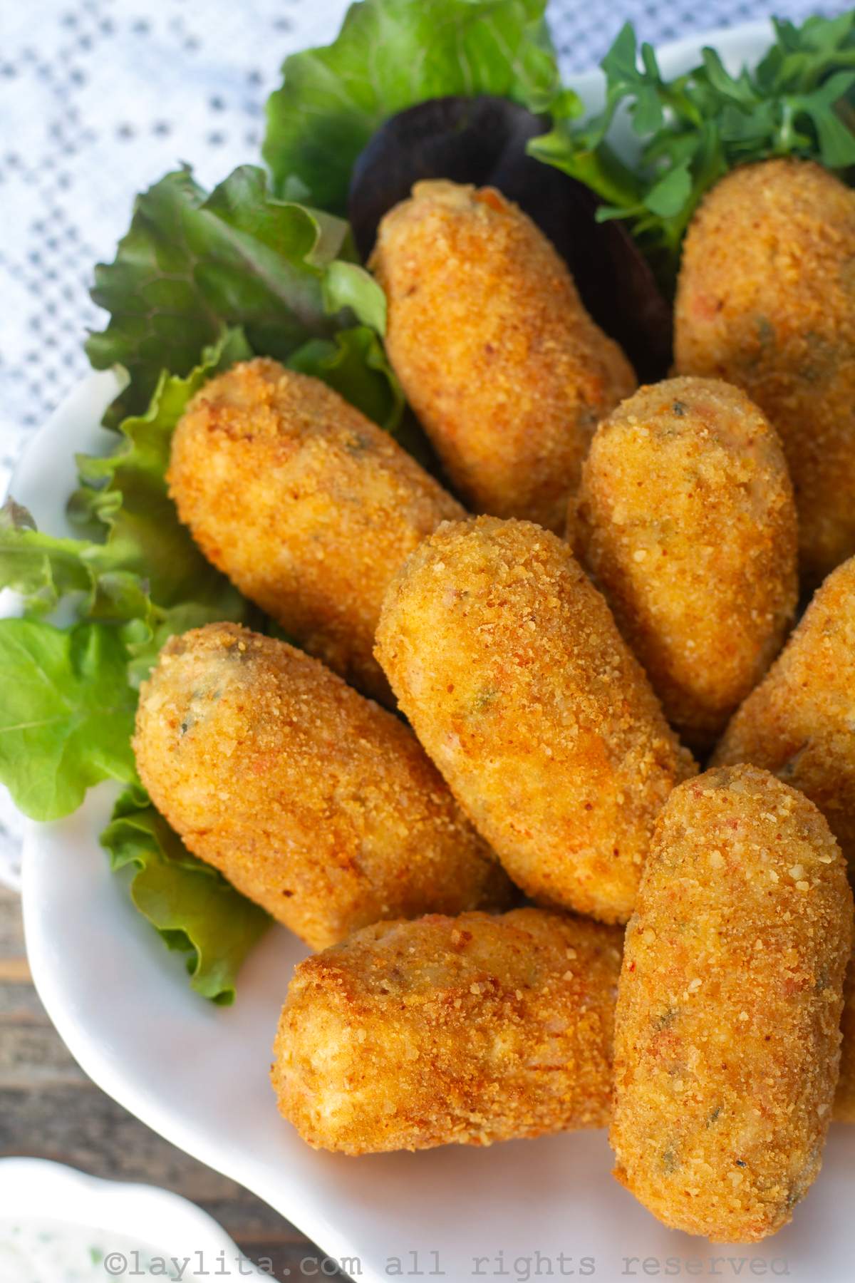 Close up of crispy crab croquettes on a plate.