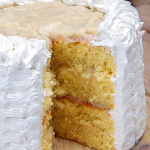 Side view of a soursop cake or torta de guanabana with a slice missing to show the inside.