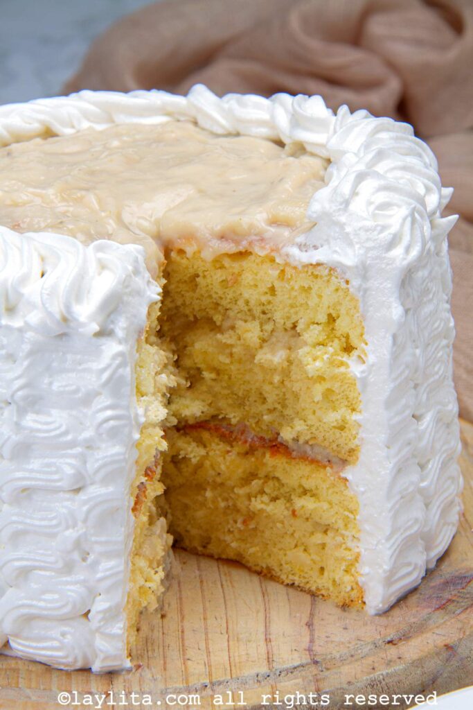 Side view of a soursop cake or torta de guanabana with a slice missing to show the inside.