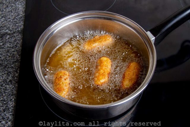 Frying crab croquettes or croquetas de cangrejo in a pot filled with oil