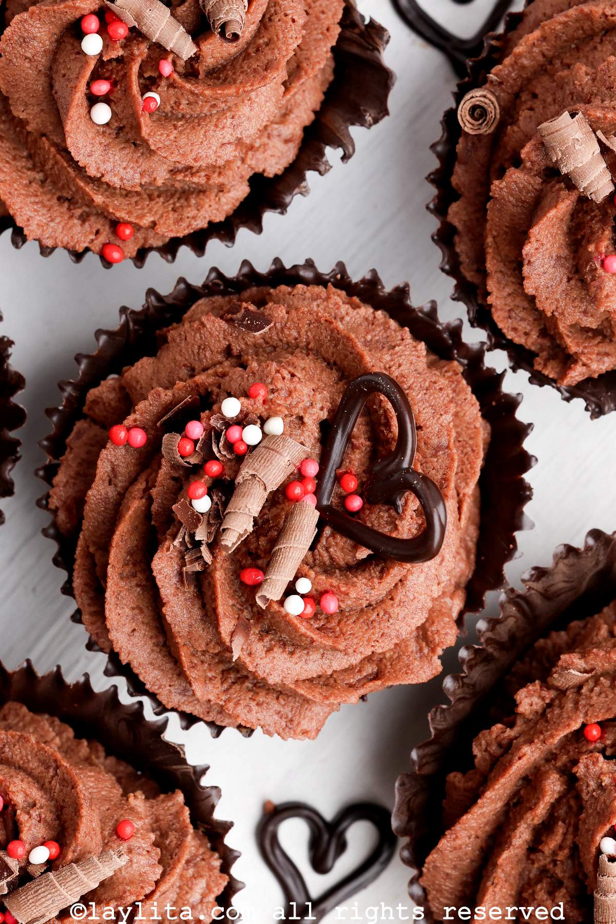 Closeup of chocolate mousse cups decorated with red and white sprinkles