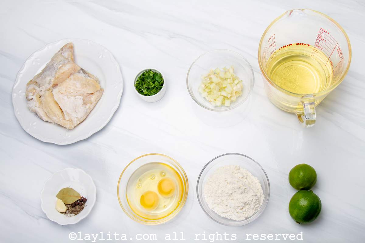 Ingredients needed to make salted cod fritters on a kitchen counter.